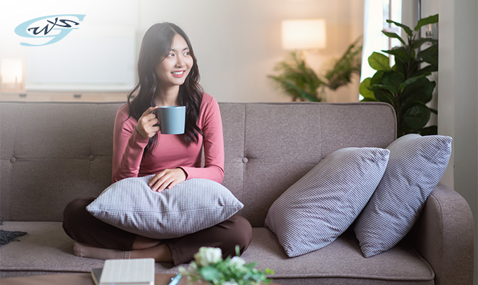 A woman relaxing on a sofa in a comfortable home.