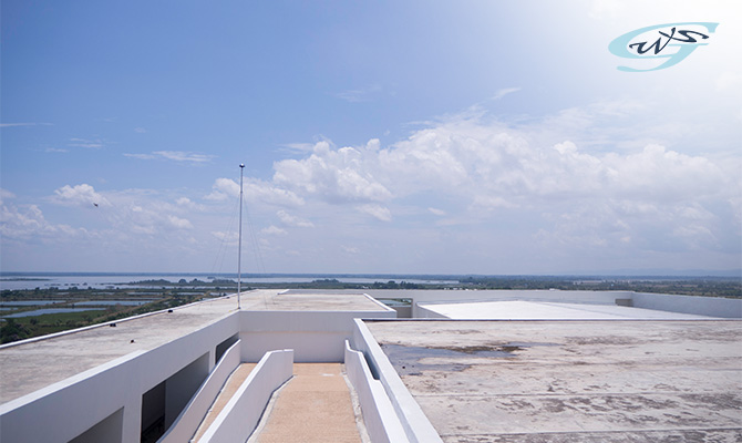 An exposed rooftop with a view of the surrounding landscape.