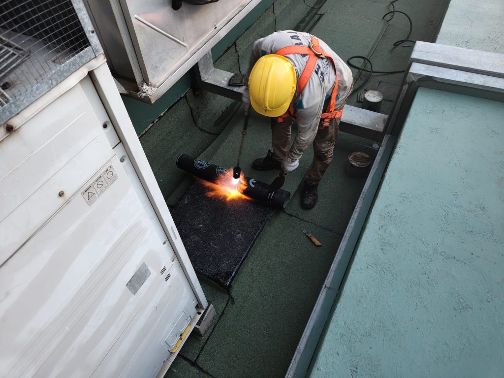 Man at works RC roof Torch on membrane.jpg